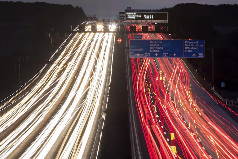 Cars driving down a highway in both directions.