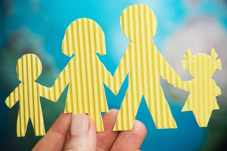 Carboard cutout of a famile: mum, day and two chilndren.