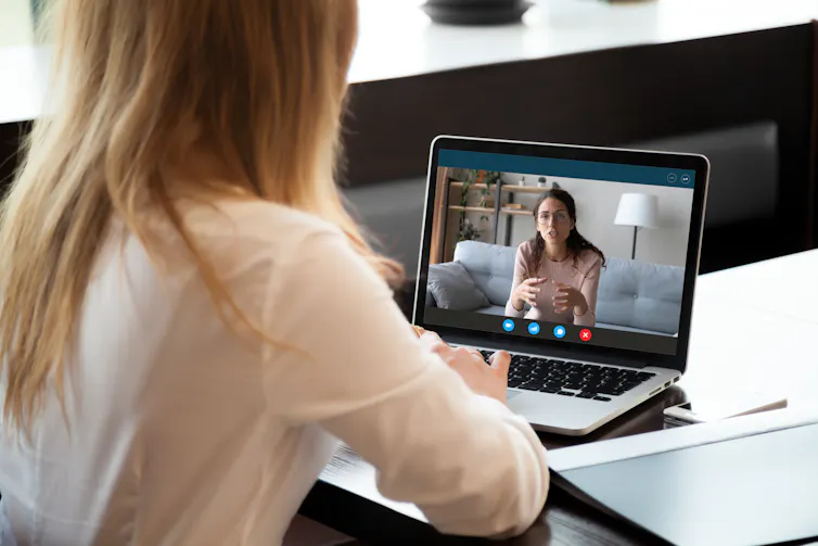 Young woman talking to woman on video call