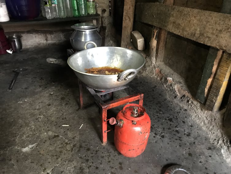 A pot of stew cooking over a stove.