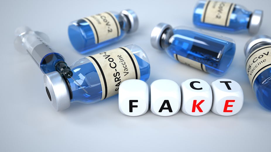 Vaccnie bottles on their sides with 'fact' and 'fake' spelt in dice