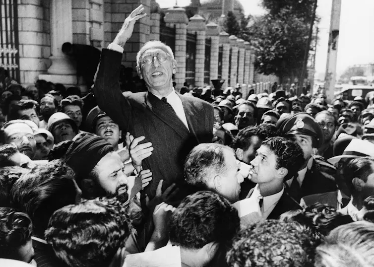 Iranian Prime Minister Mohammad Mosaddegh rides on the shoulders of cheering crowds.