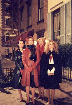 4 women in coats on street