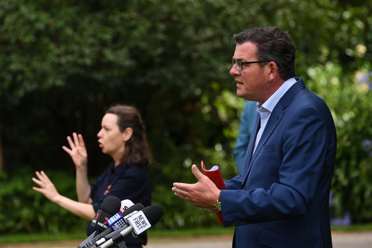 Dan Andrews and interpreter at a press conference