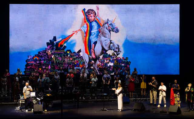 George Michael rides a unicorn over the stage