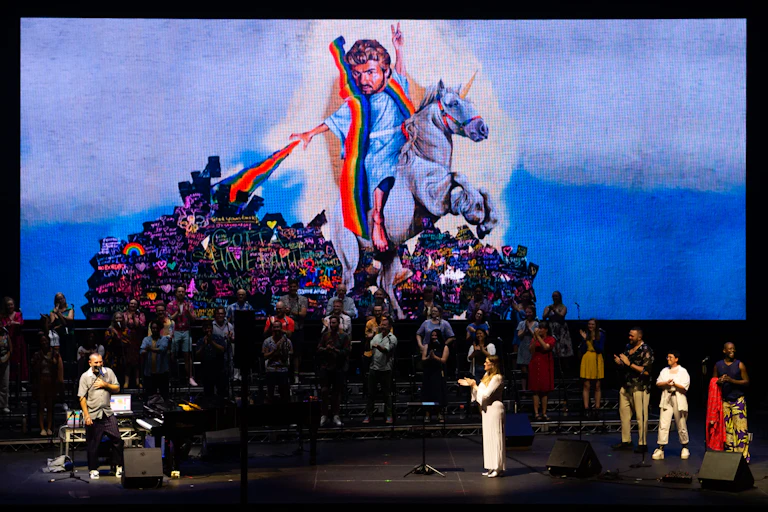 George Michael rides a unicorn over the stage