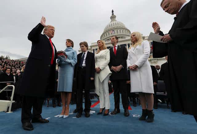 Trump taking the oath of office in 2017, with his family present.