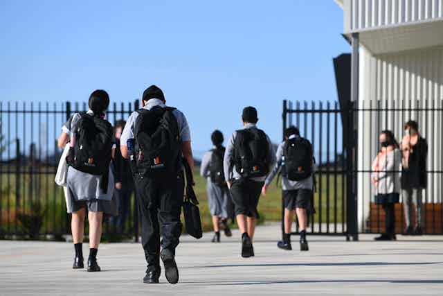 Students in Australian school walking into school gates.