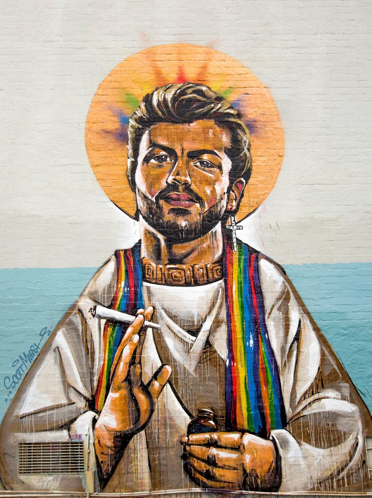 George Michael in priestly robes with a cross dangling from one ear, his head surrounded by a rainbow-coloured halo and smoking marijuana