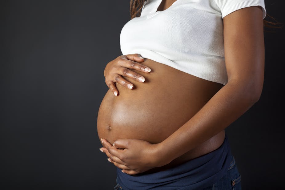 Pregnant African Woman Holding Her Belly