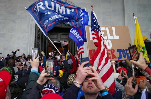 Trump supporters used their phones to take pictures as they gather outside the Capitol in Washington on Jan.6. 