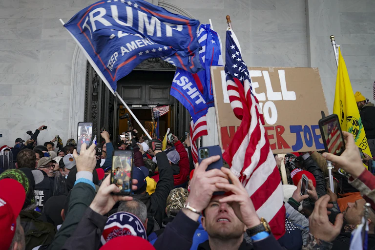 Trump supporters used their phones to take pictures as they gather outside the Capitol in Washington on Jan.6.