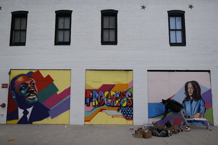 A mural depicts Martin Luther King on the left and Kamala Haris on the right.