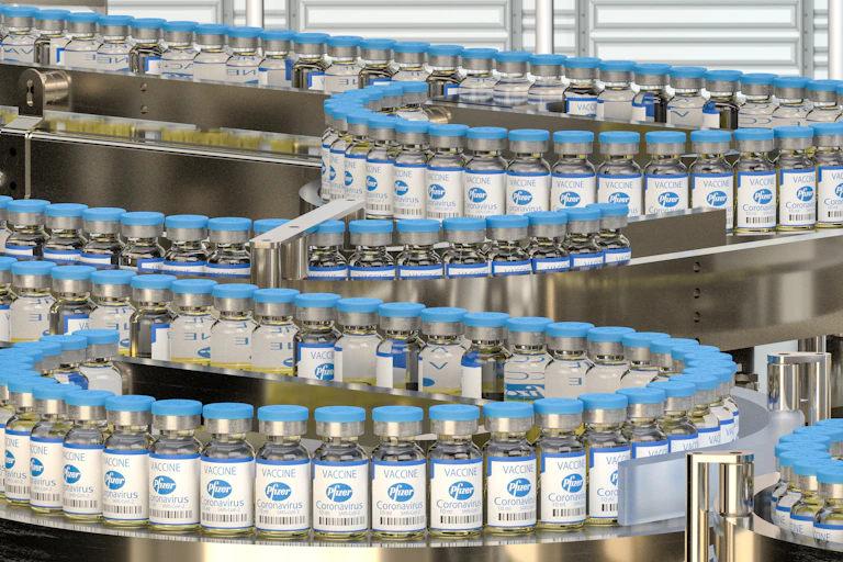 Pfizer vaccine vials on conveyer belt