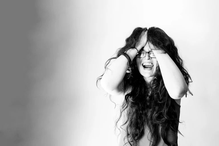 Woman screaming, holding her head