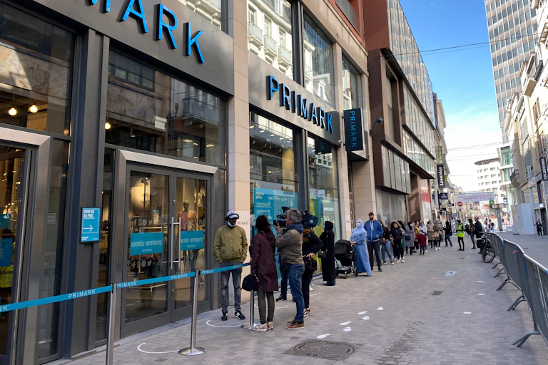 Clients queue to enter in shops of rue Neuve the main commercial street of Brussels, Belgium, 11 May 2020. Authorities allowed non-essential shops to open their doors to clients as of 11 May.