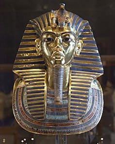 The gold and blue funerary mask of the ancient Egyptian pharaoh Tutankhamun.