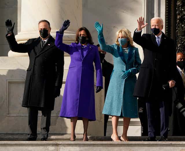 Joe Biden, Kamala Harris and their spouses wave on the steps of the U.S. Capitol.