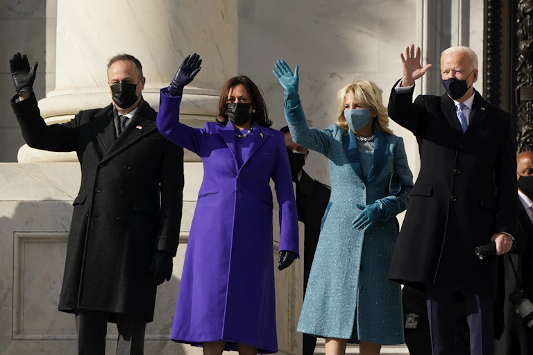 Joe Biden, Kamala Harris and their spouses wave on the steps of the U.S. Capitol.