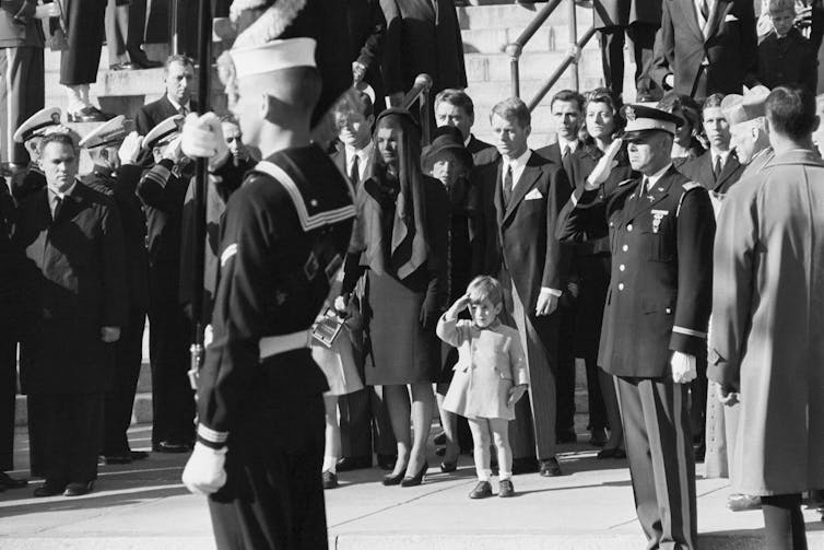John F. Kennedy Jr. salutes as the casket of his father, the late President John F. Kennedy, is carried from St. Matthew's Cathedral in Washington, DC.