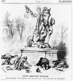 An illustration of Andrew Jackson riding a horse on a statue with the words, 'To the victors belong the spoils,' while several men seeking jobs bow down to him.