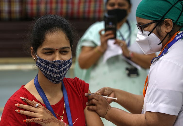 A woman received a COVID vaccine in India.
