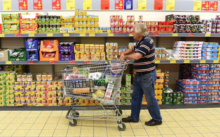 Older man shopping in Aldi store on the Gold Coast, Queensland.
