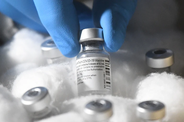 Vials of Pfizer's COVID-19 vaccine in a box, wrapped in cotton wool.