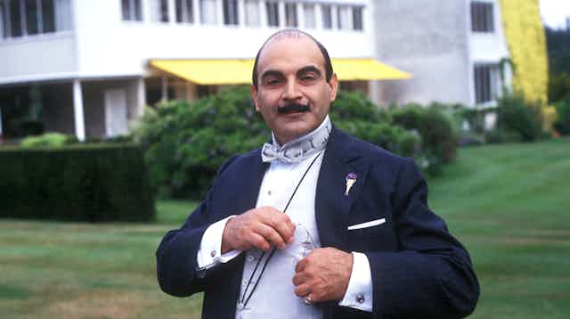 Man with moustache in suit.