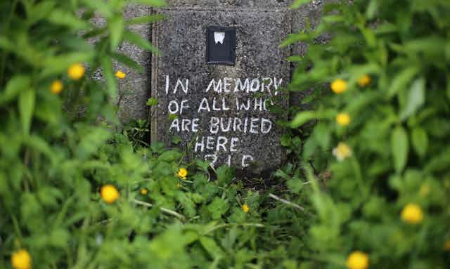Crudely drawn memorial message on unmarked mass grave in Tuam.