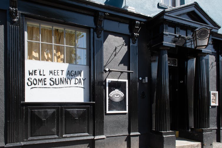 A closed UK pub with message 'We'll meet again some sunny day' in window during lockdown