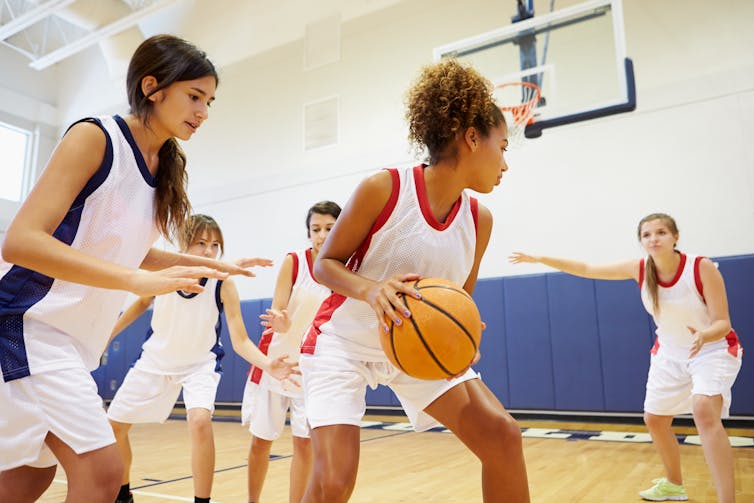 Young women playing basketball