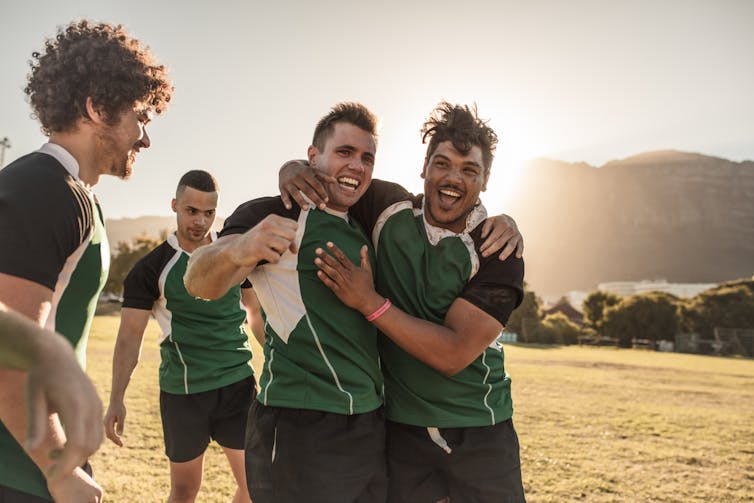 Young men celebrating after a rugby game