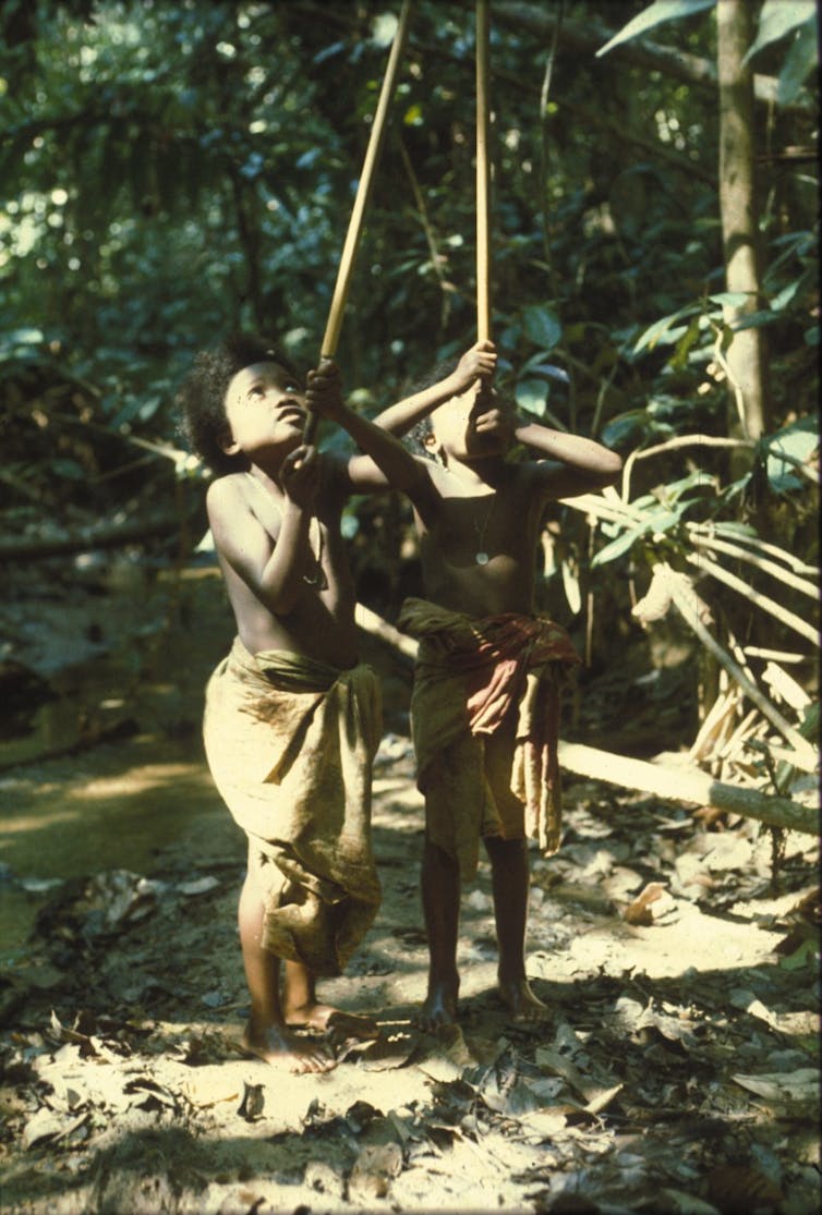 Two girls playing with blowpipes