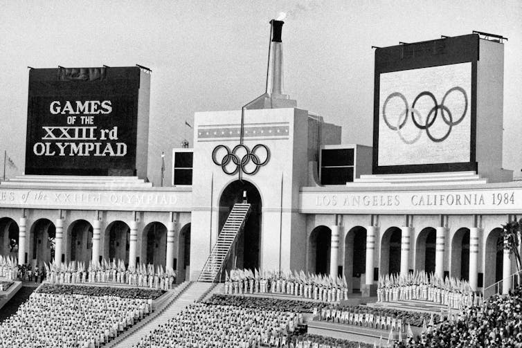 The Olympic flame is flanked by scoreboards signifying the formal opening of the the 1984 Summer Olympic Games in Los Angeles