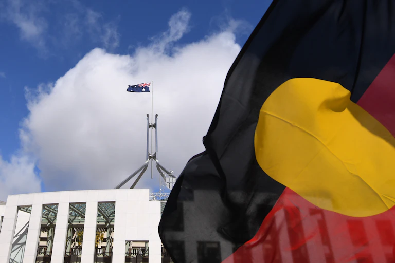 The Aboriginal flag flies in front of Federal Parliament