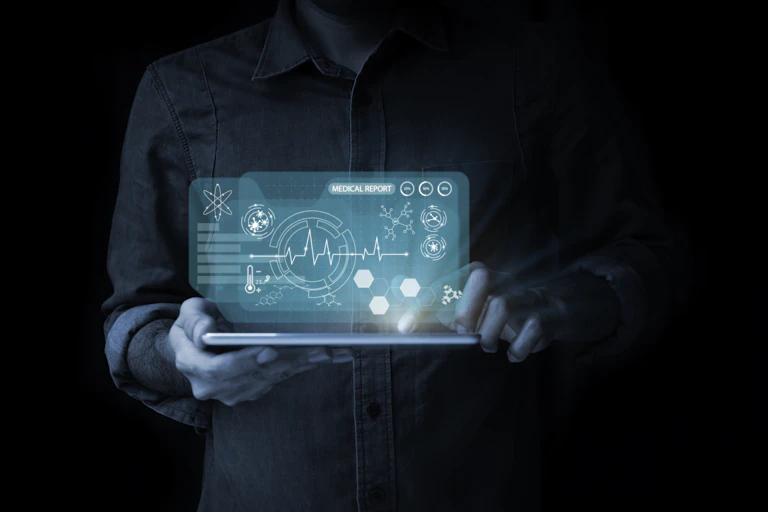 A man points to digital tablets with virtual screen icons and health examination reports.