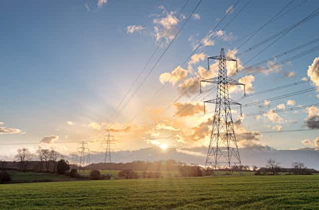 Electricity pylon in field with sunshine 