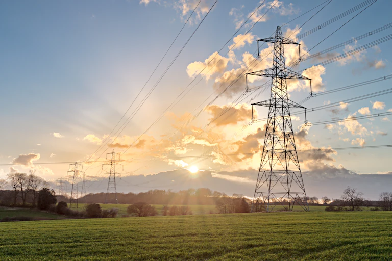 Electricity pylon in field with sunshine