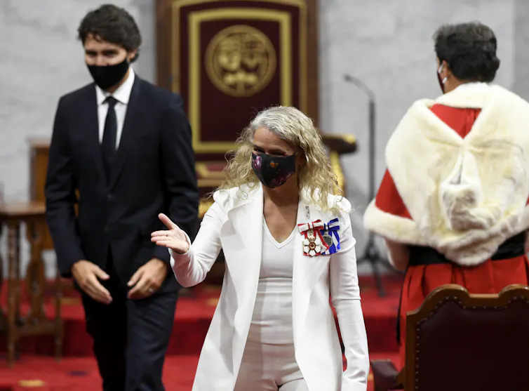 Julie Payette walks ahead of Justin Trudeau as they leave the Senate chamber at Canada's Parliament building