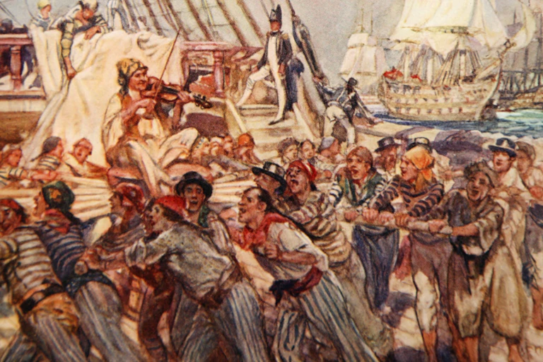 Sailors work in concert aboard a ship.
