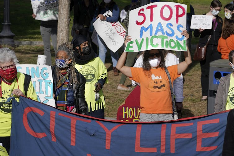 Protesters display placards during a demonstration to support for tenants and homeowners at risk of eviction in Boston on Oct. 11.