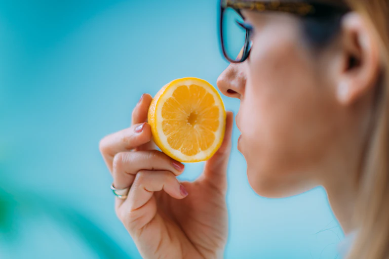 Person smelling a lemon