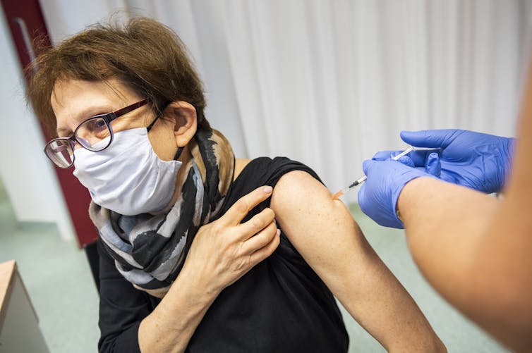 A health-care worker receives the Pfizer vaccine in Hungary.
