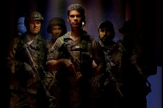 Screenshot: five soldiers look towards the camera