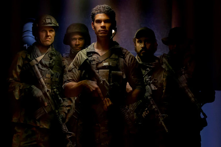 Screenshot: five soldiers look towards the camera