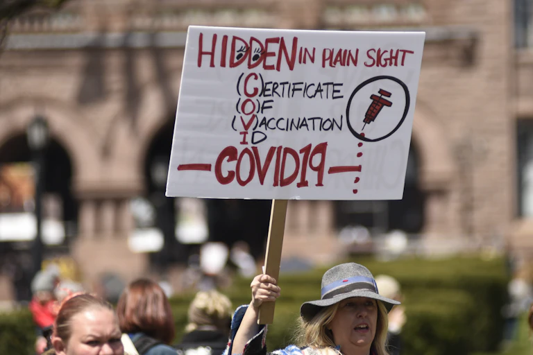 Anti-vaxxer holds up sign in protest.