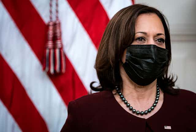 Vice President Kamala Harris wearing face mask in front of US flag