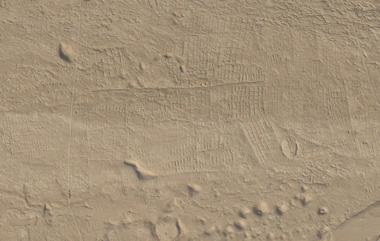 Dusty ground with lines and box shapes.