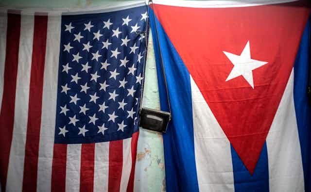 American and Cuban flags hang next to each other.
